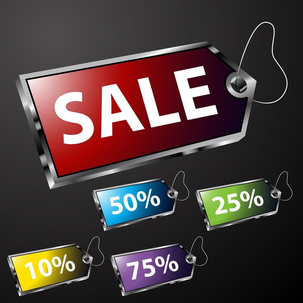 Scissors cutting through various sale and discount coupons.