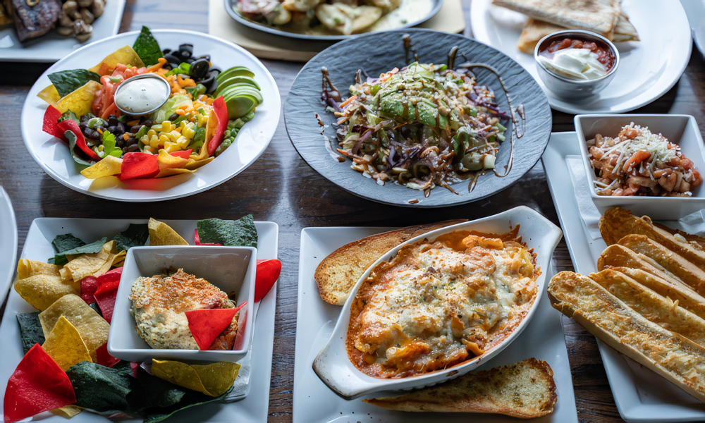 A variety of plates of food are on a table Ann Arbor Restaurants