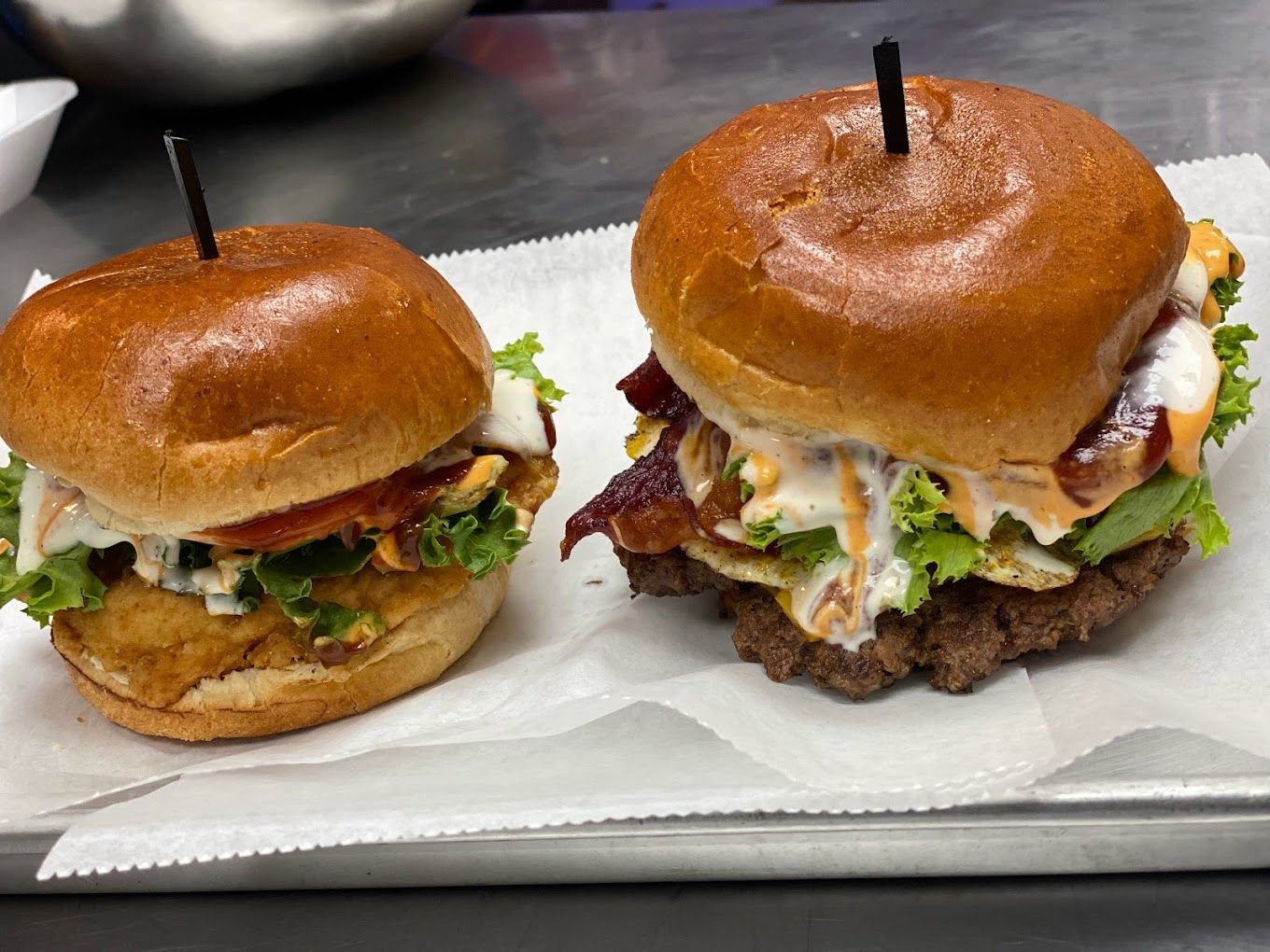Two hamburgers on a tray with toothpicks in them Blazin Burger Ypsilanti MI