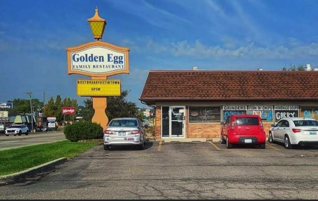 Cars are parked in front of a restaurant called golden egg Ypsilanti MI