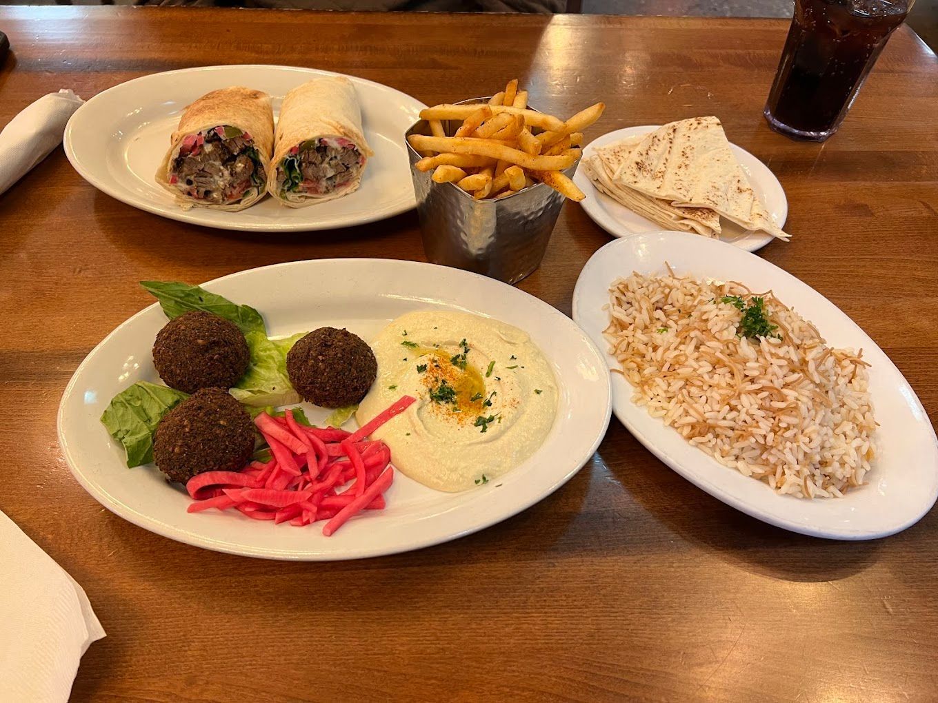 A table topped with plates of food including falafel and hummus Jerusalem Garden Ann Arbor MI