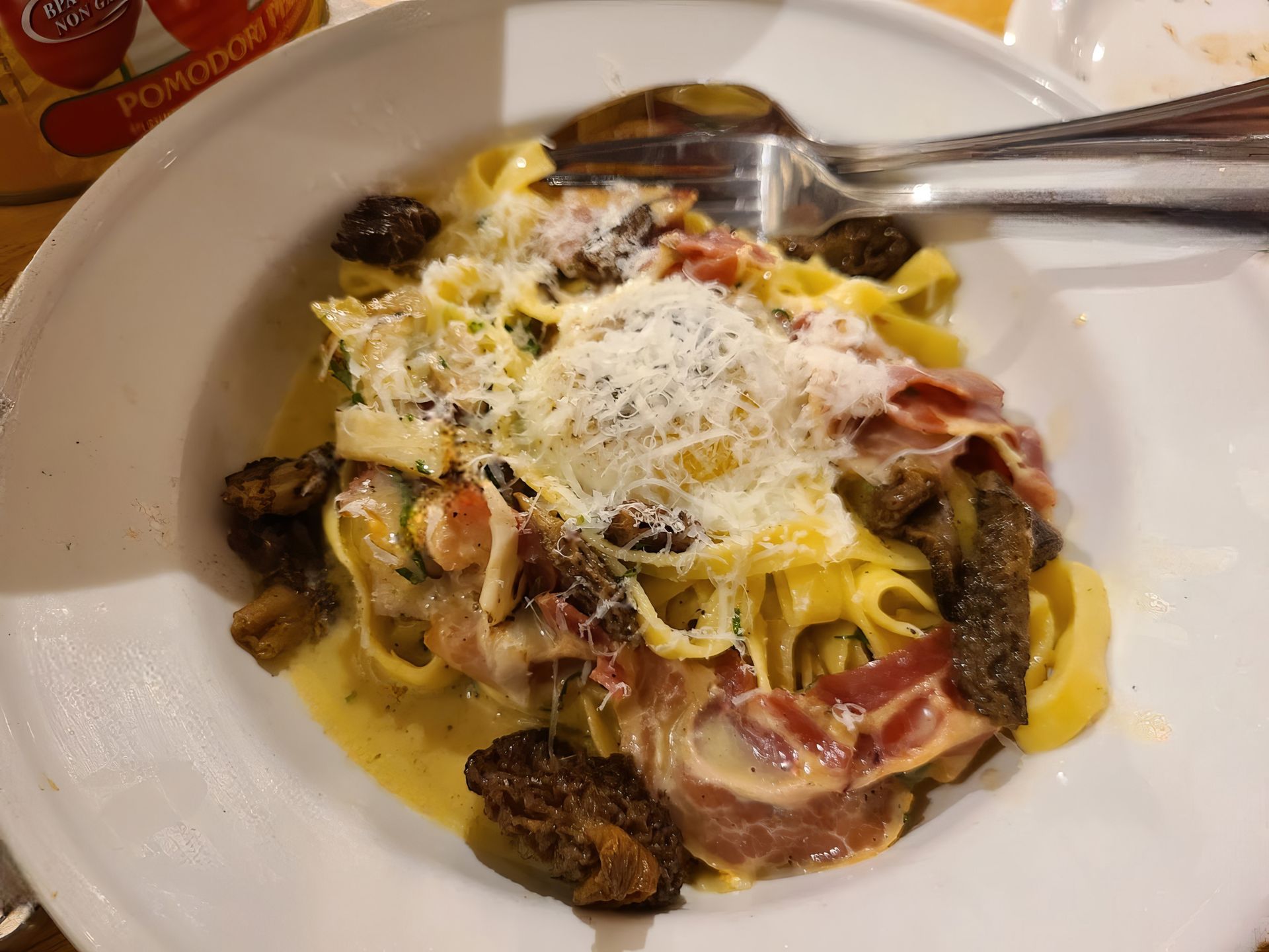 A close up of a plate of pasta with a fork and spoon Mani Osteria Bar Ann Arbor MI