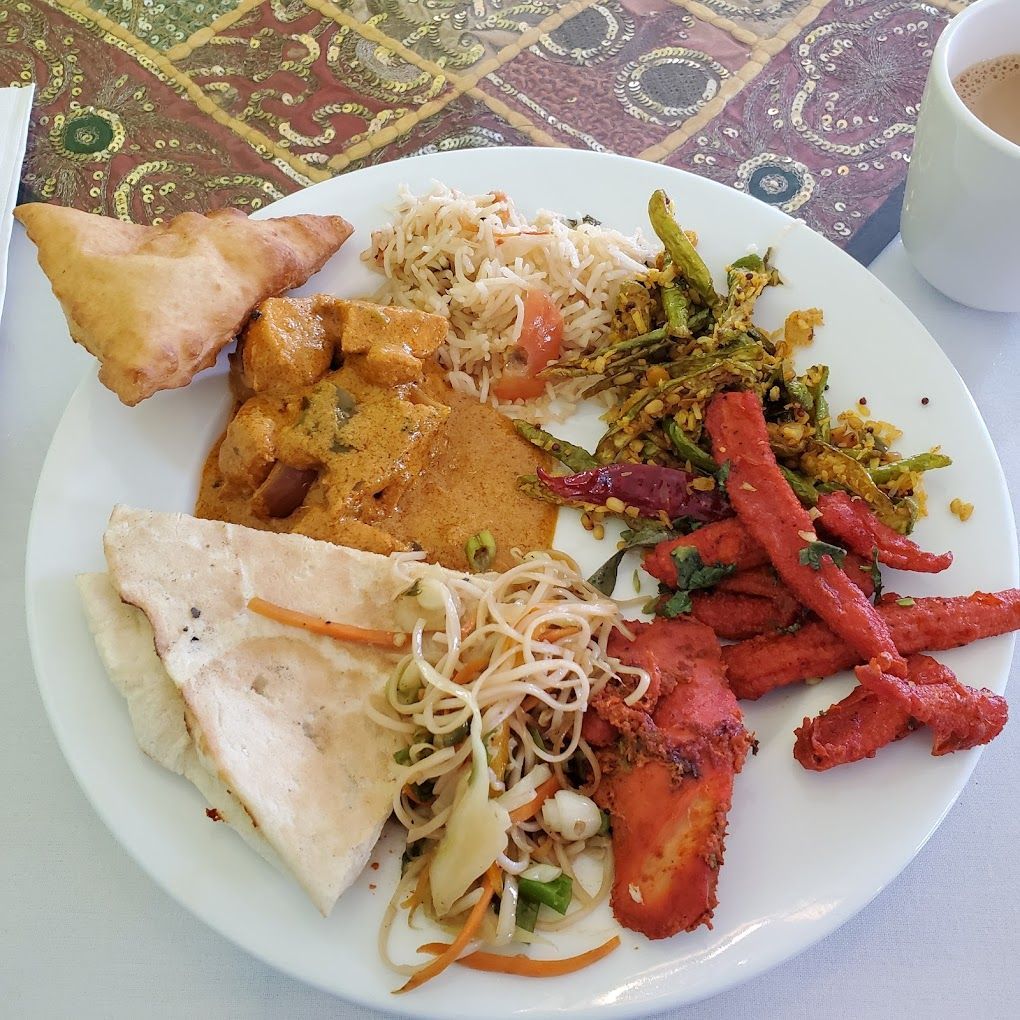 A plate of food with a cup of tea in the background Namaste Flavours Arbor Ann Arbor MI