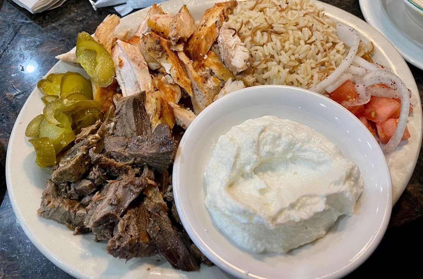 A plate of food with a bowl of sour cream on the side Pita Pita Ypsilanti MI