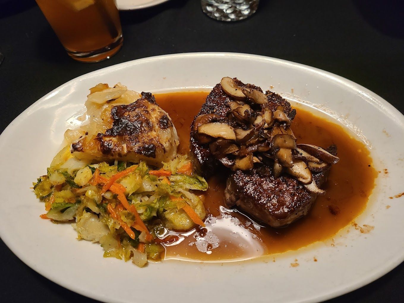 A white plate topped with meat and vegetables on a table The Earl Restaurant Ann Arbor MI