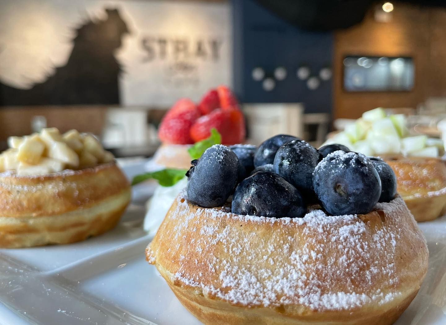 A stack of pancakes with whipped cream and berries on top The Hen Ann Arbor. Restaurant