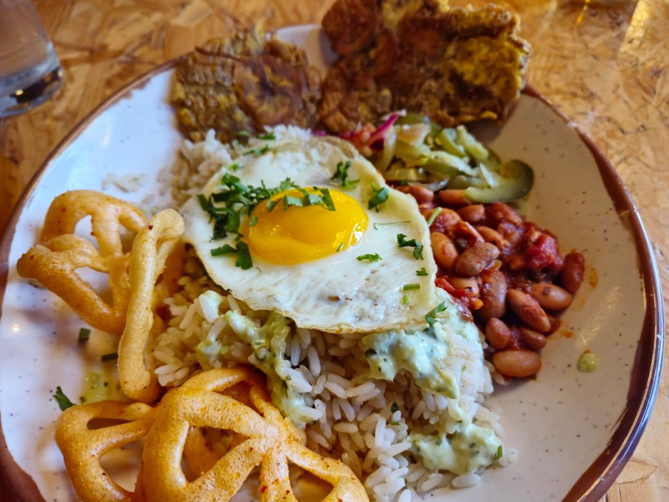 A plate of food with rice beans and an egg on top Union Rec Restaurant Ann Arbor MI