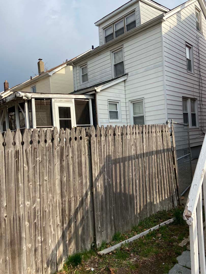 Old Wood Fence in Front of House