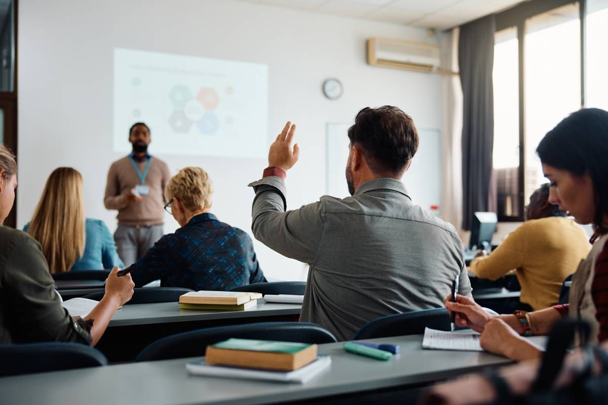 A view from the back of a classroom with adult real estate students at HomeServices Real Estate Academy near Lexington, KY