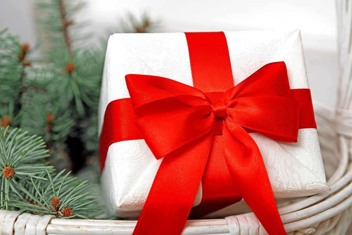 A gift basket on a kitchen counter decorated with a red bow near Lexington, Kentucky (KY)