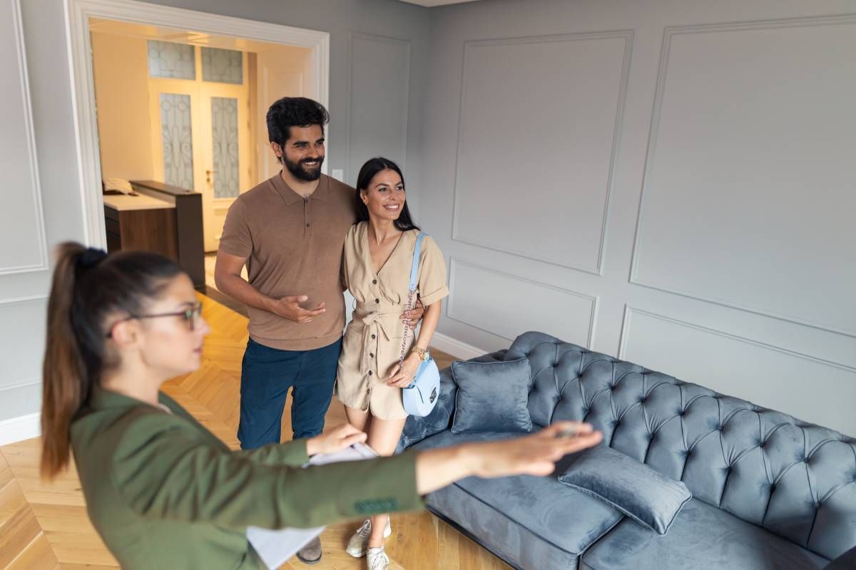 People touring a new home with a real estate salesperson at HomeServices Real Estate Academy near Lexington, KY