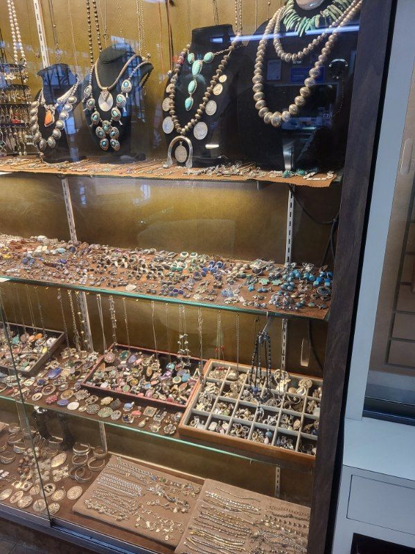 Jewelry display case filled with necklaces, rings, and earrings.