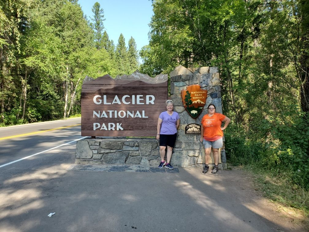 Posing at the Glacier National Park sign