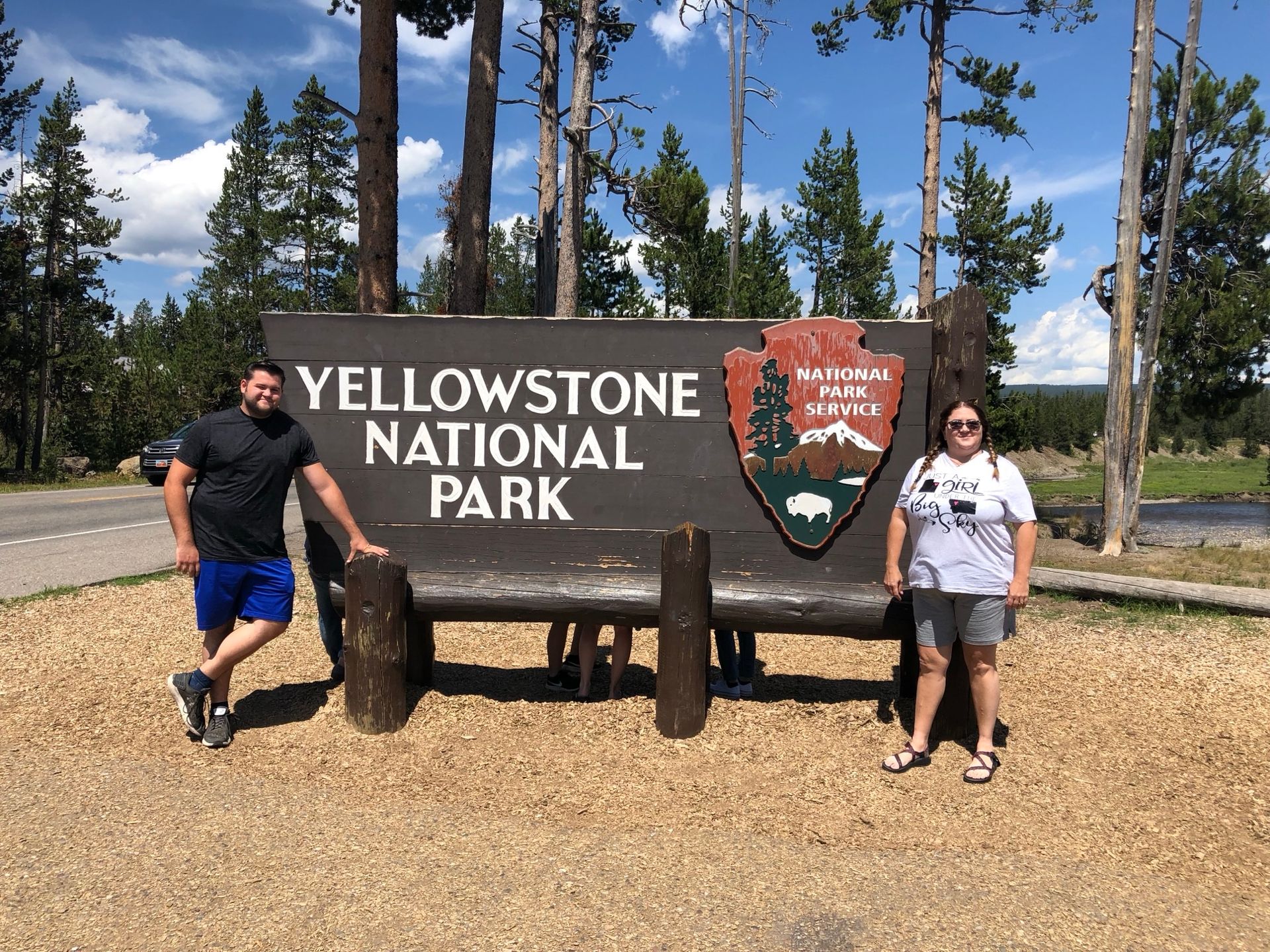 Posing next to the Yellowstone National Park sign