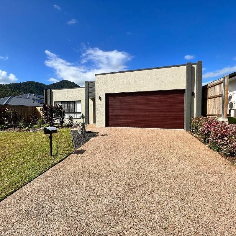 A House With A Mailbox In Front Of It And Mountains In The Background — Rental Revolution In Manoora, QLD