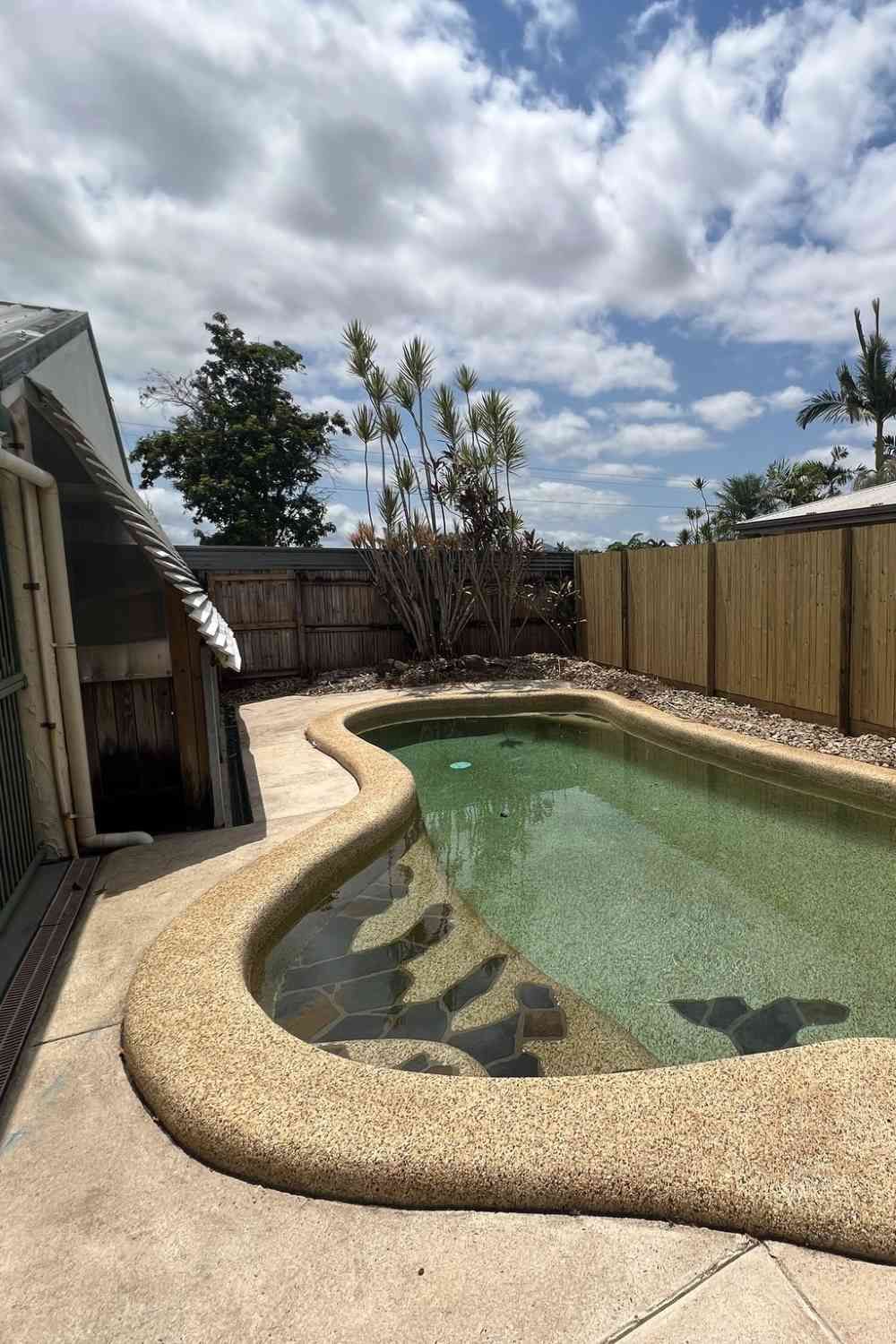 There Is A Large Swimming Pool In The Backyard Of A House — Rental Revolution In Manoora, QLD