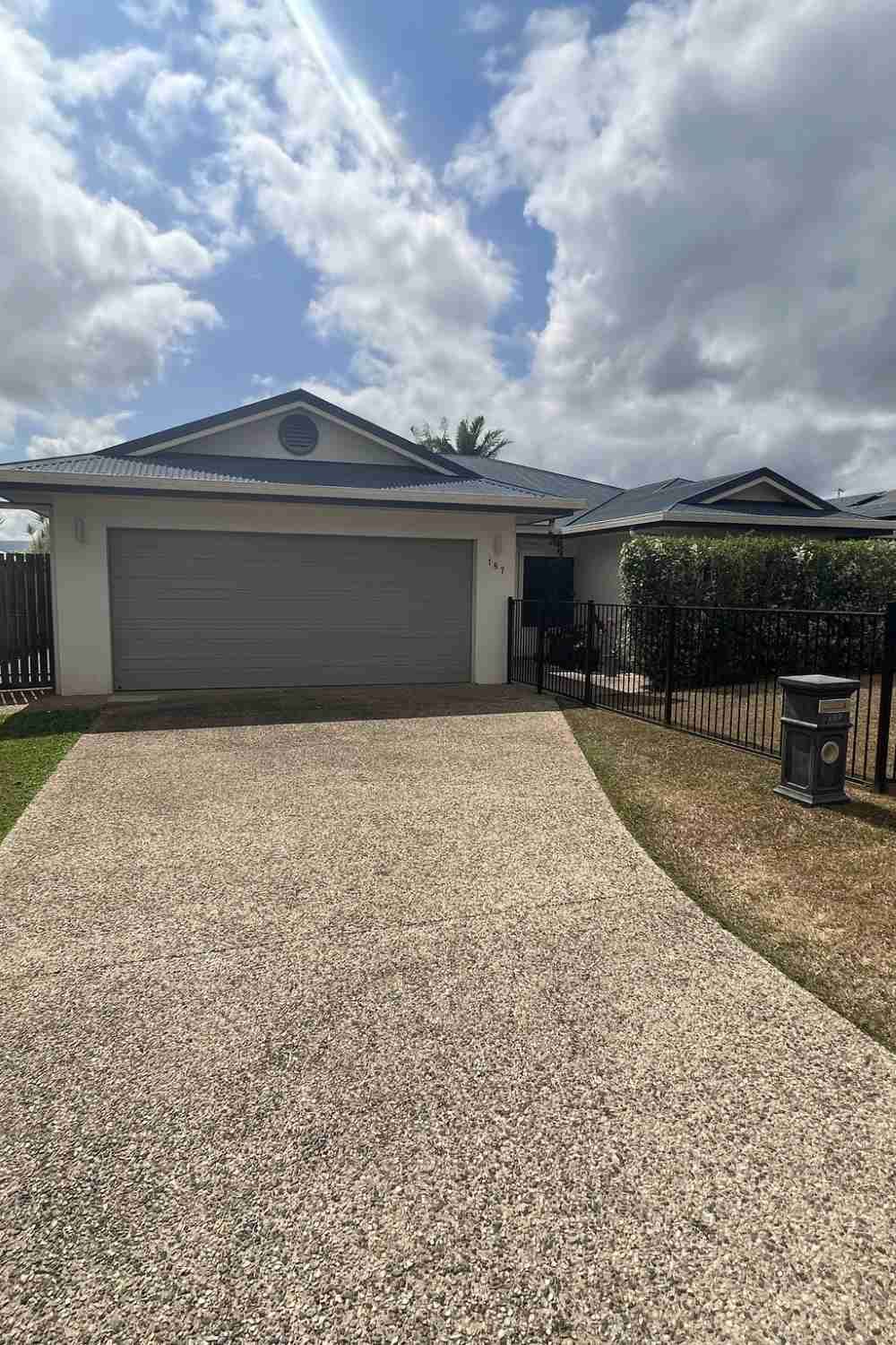 A House With A Garage And A Driveway In Front Of It — Rental Revolution In Manoora, QLD