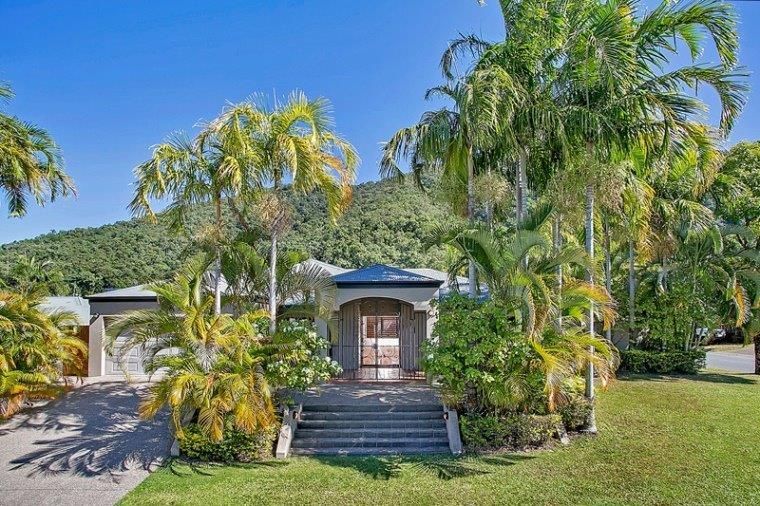 A Driveway Leading To A House With A Red Garage Door — Rental Revolution In Manoora, QLD