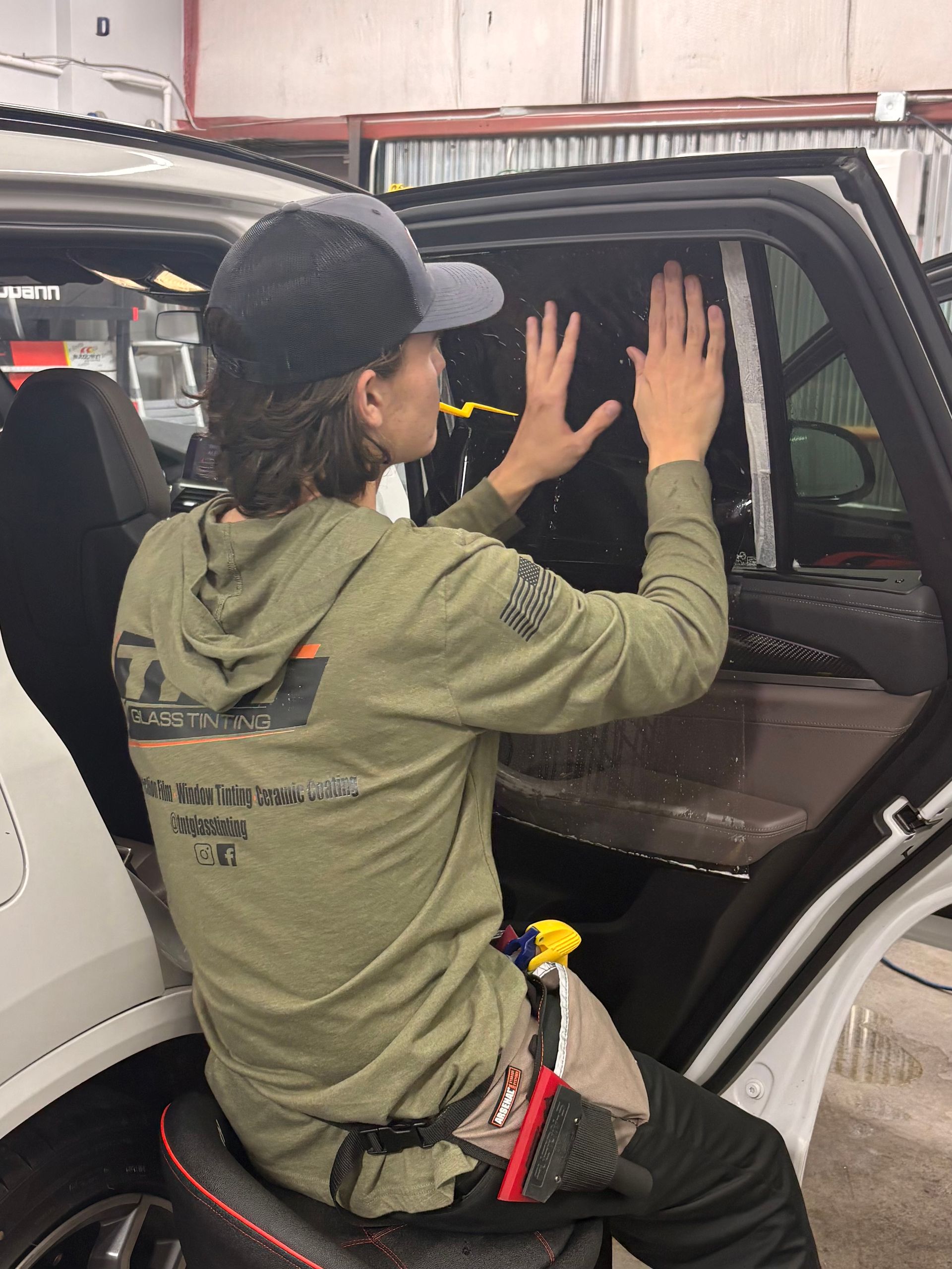 A group of people are sitting at a long table with plates of food.