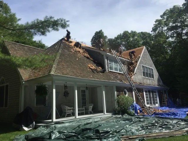 A man is working on the roof of a house.