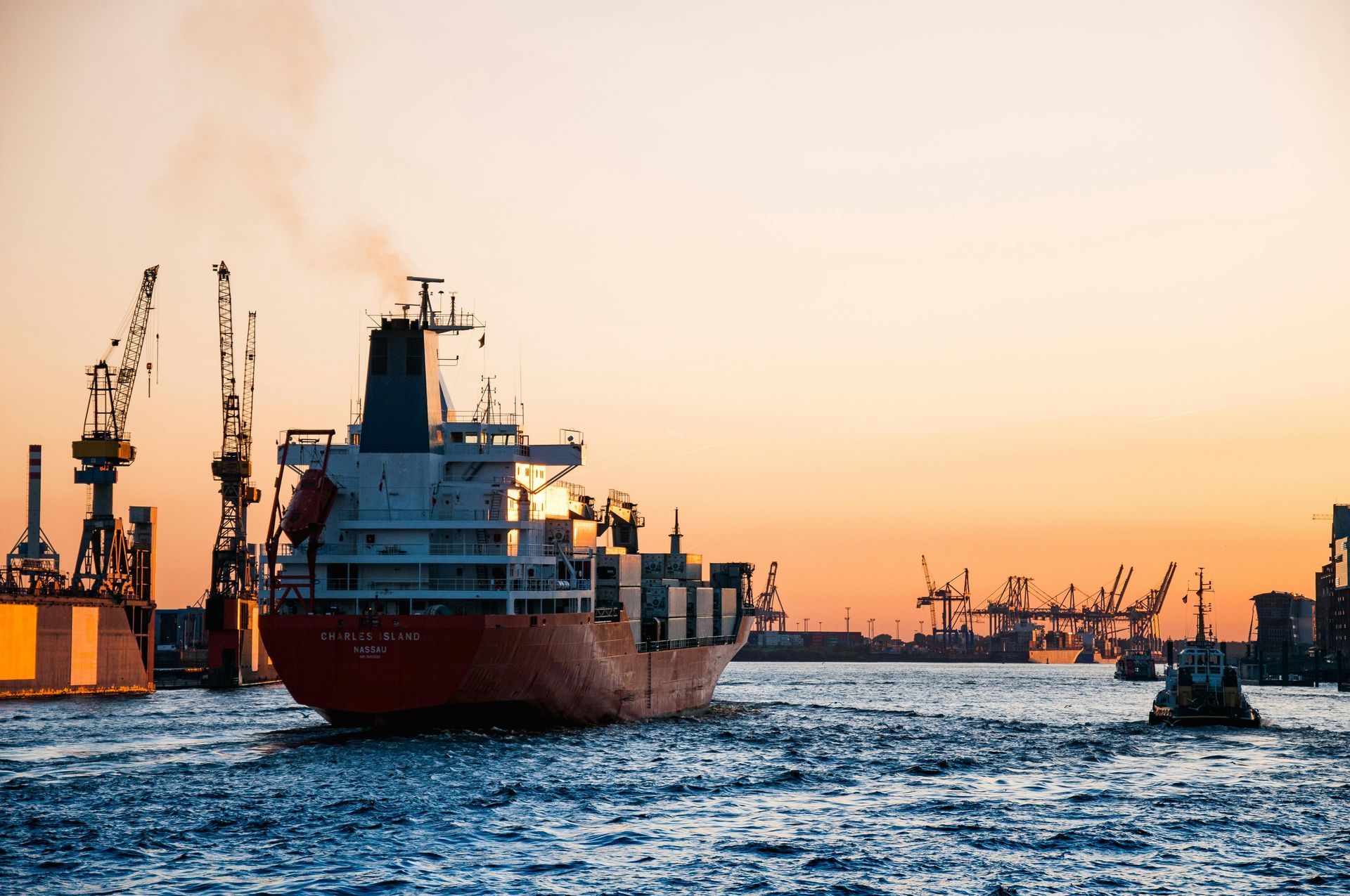 A ship at a port at sunset