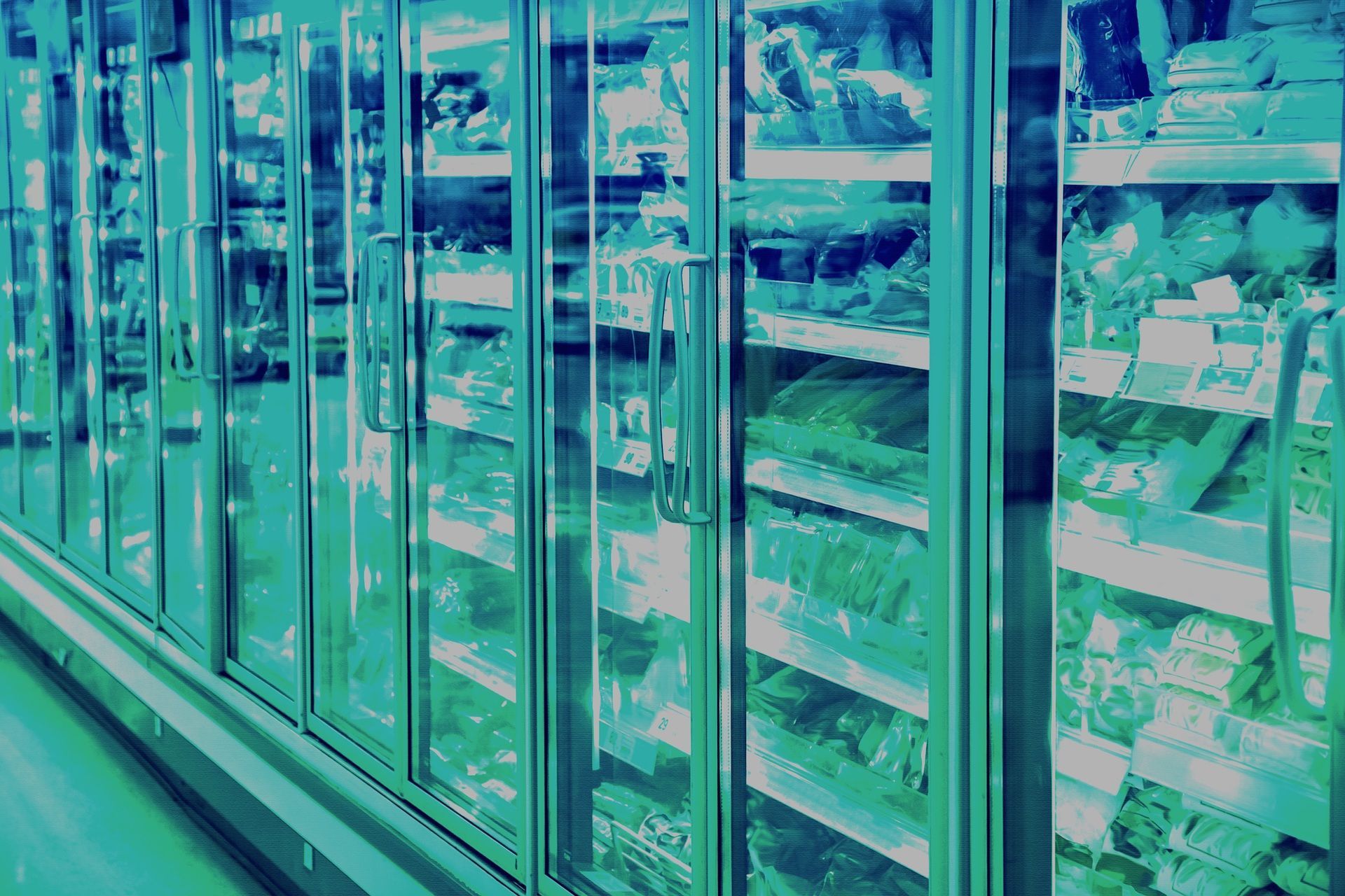 Row of freezers and foods in a store - blue/green filter