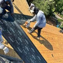A group of people are working on a roof.