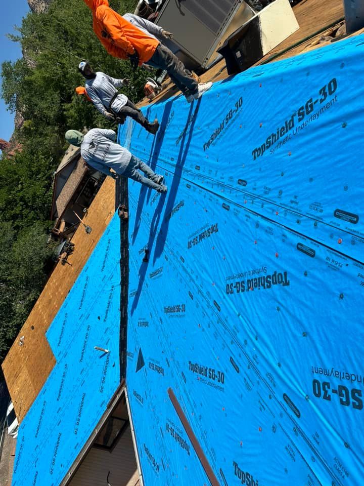 A group of people are working on a roof.
