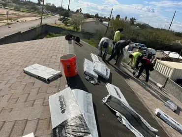 A group of people are working on a roof.