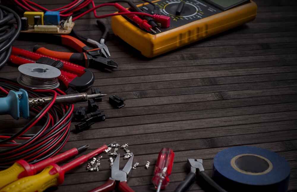 A Bunch Of Electric Tools Are On A Wooden Table — Bastion Electrical In Cordeaux Heights, NSW