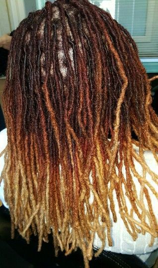 Woman with brown and blonde ombre locs.