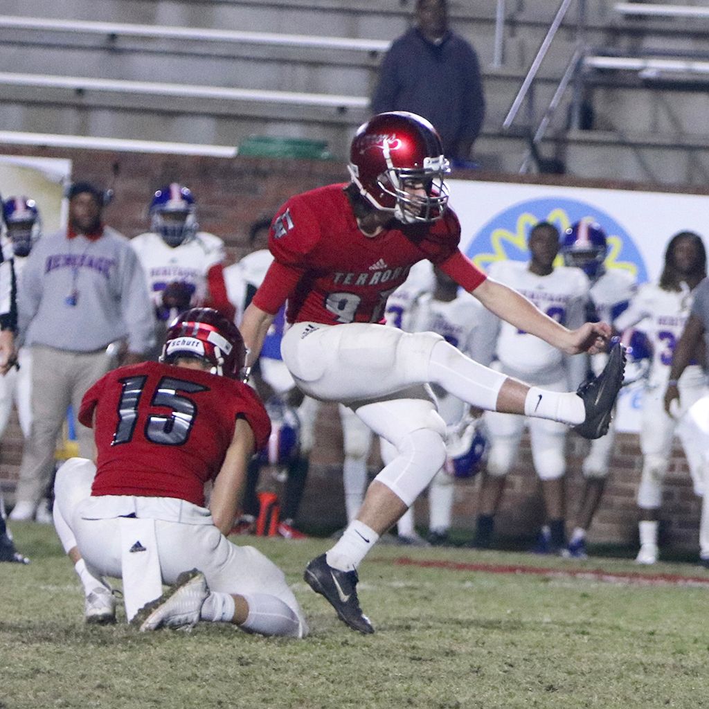 Football player in red jersey kicking