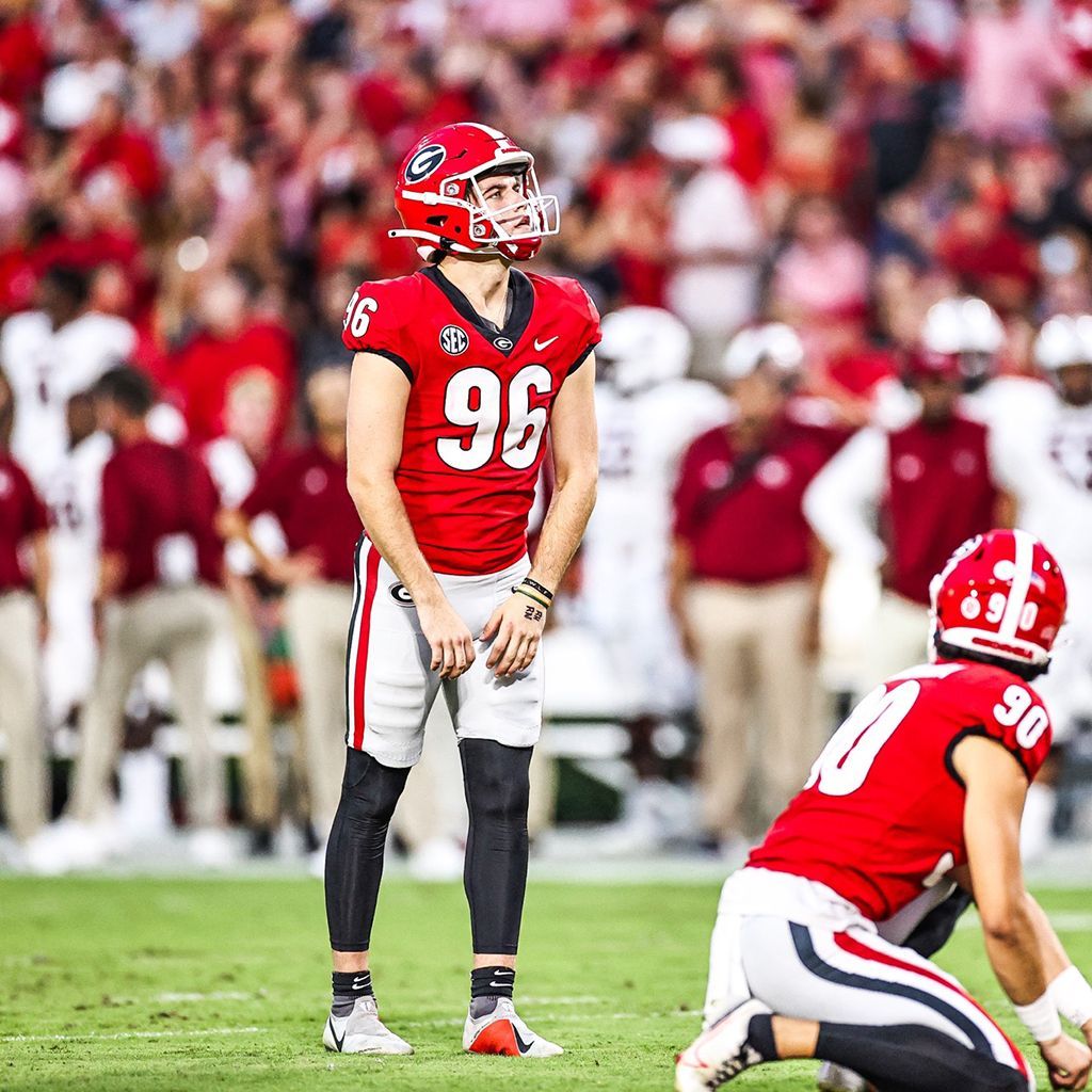 A football player wearing jersey 96 looking to his fans