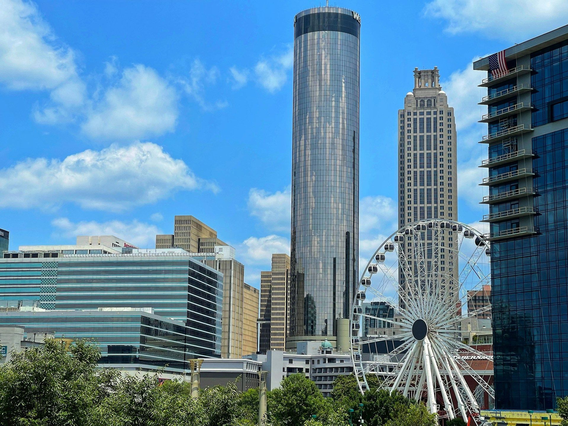 A city skyline with a ferris wheel in the foreground