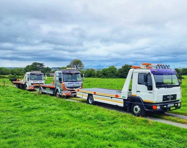 tow truck loading broken down car on urban road in Tallaght Dublin