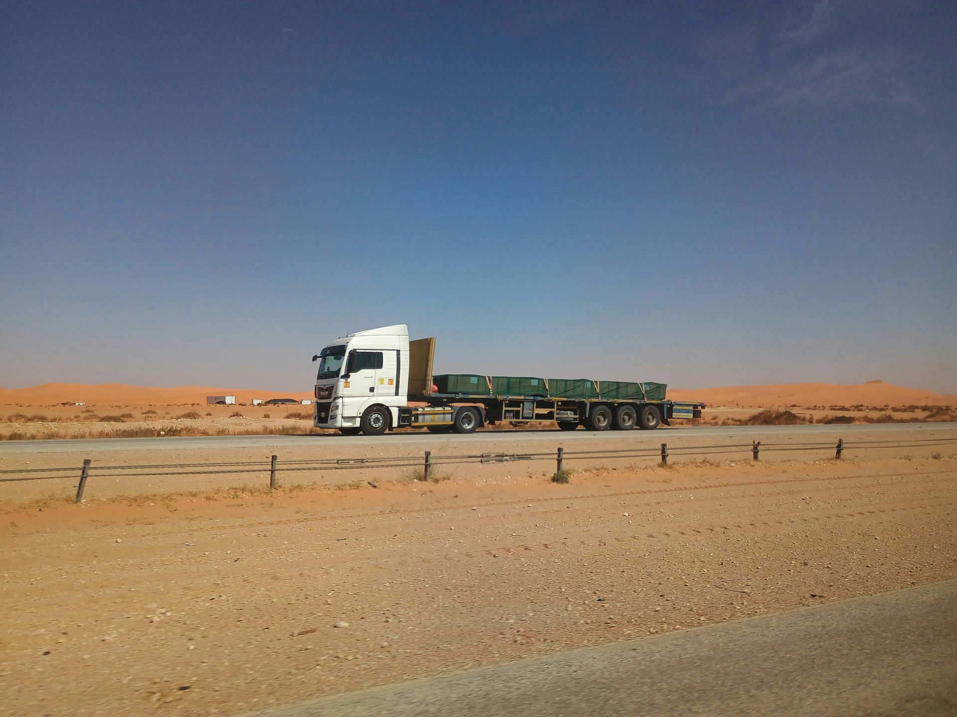 Big truck with flatbed on the road driving