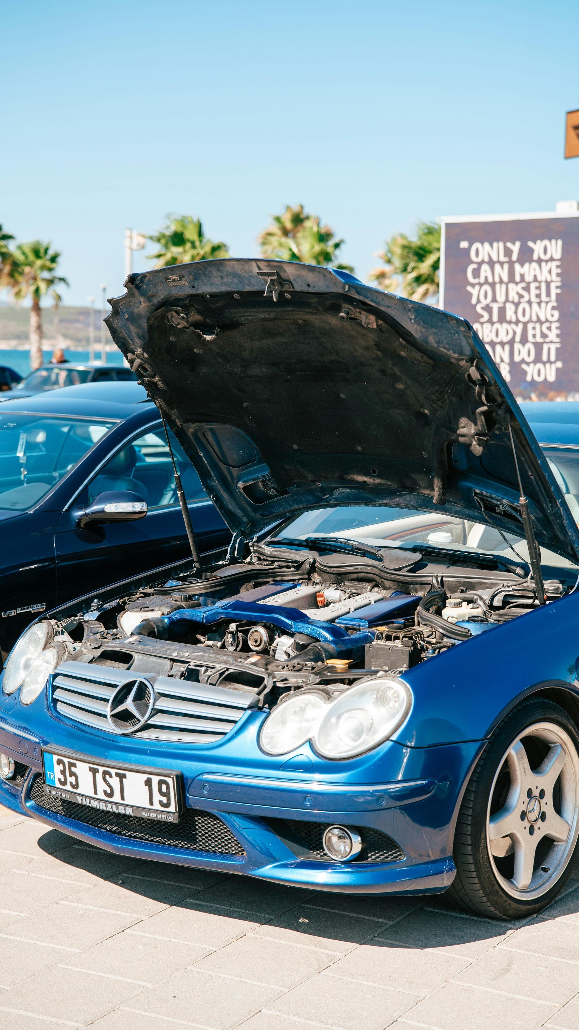 black car breakdown blue sky