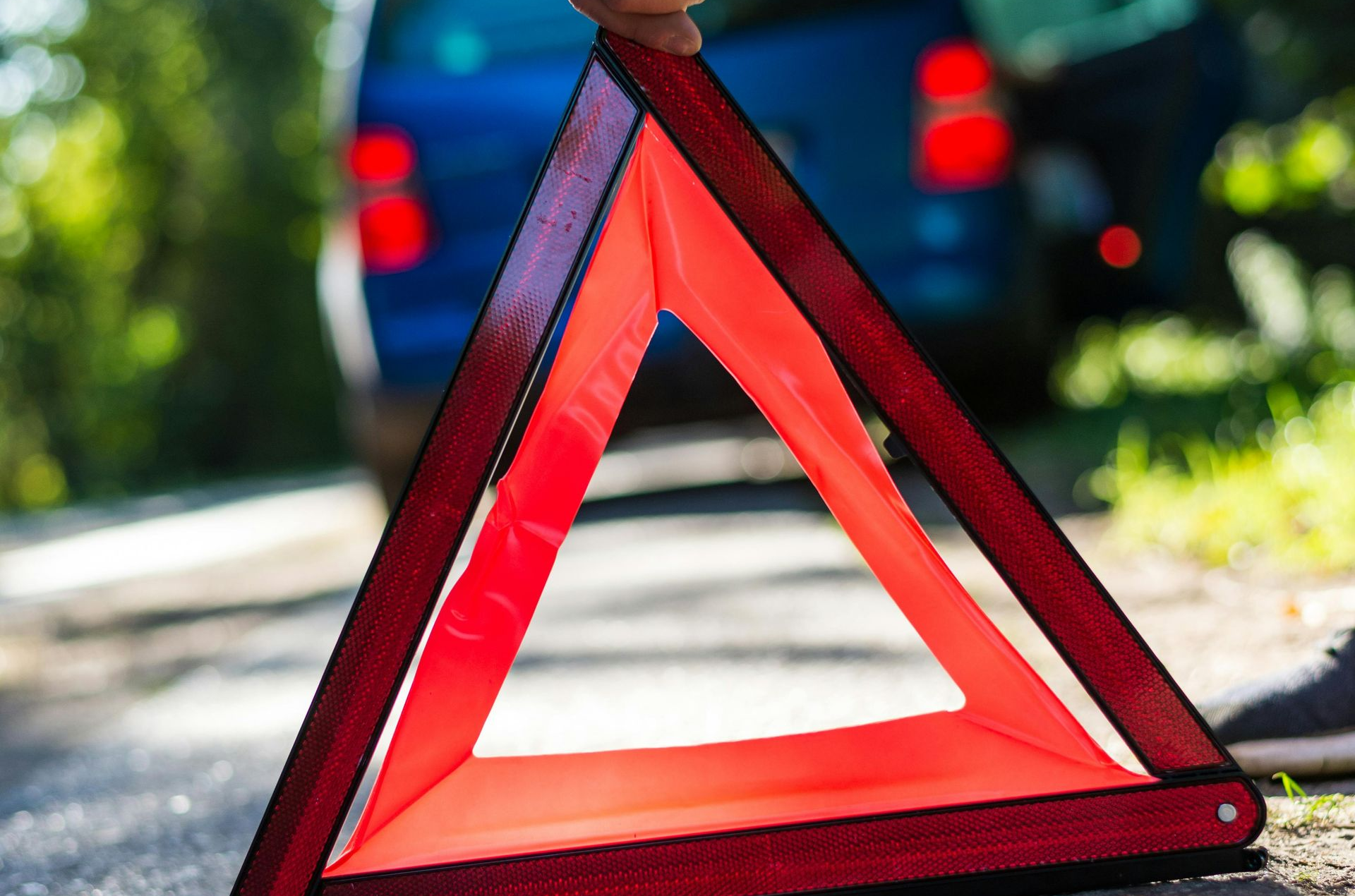 Red Warning triangle placed on the side of the road