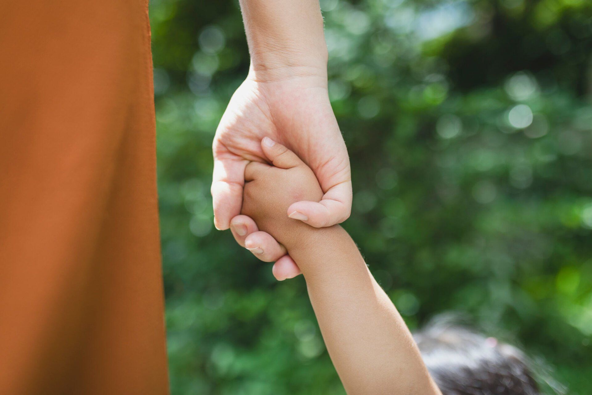 Mother holding child's hand — Jacksonville, FL — Beaches Family Law