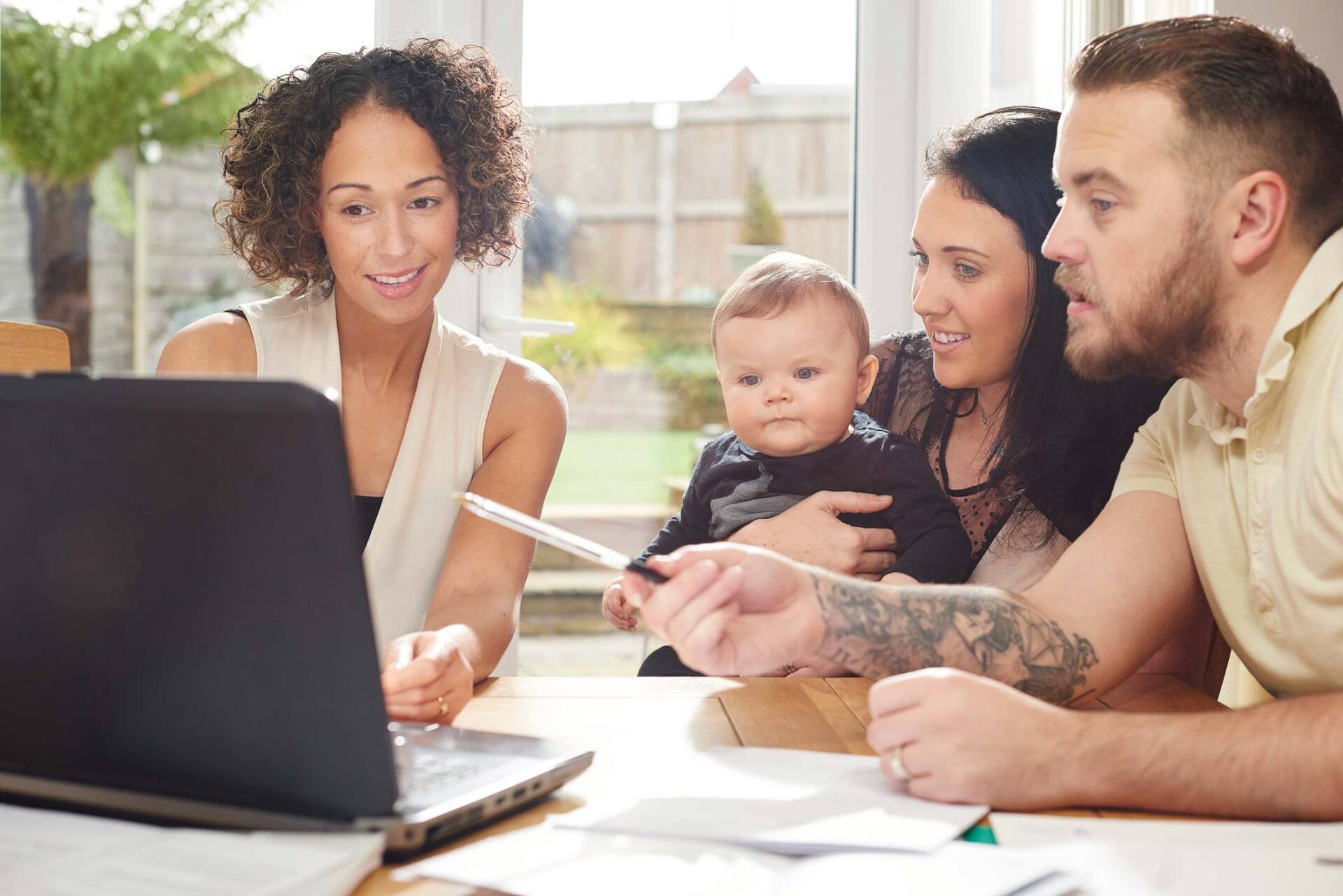 Woman talking to parents with baby — Jacksonville, FL — Beaches Family Law