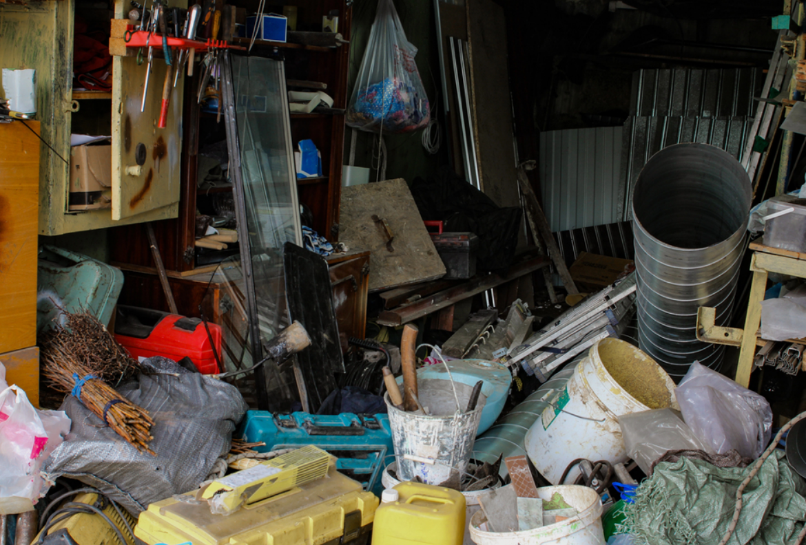Messy garage that needs garage and storage cleanout.