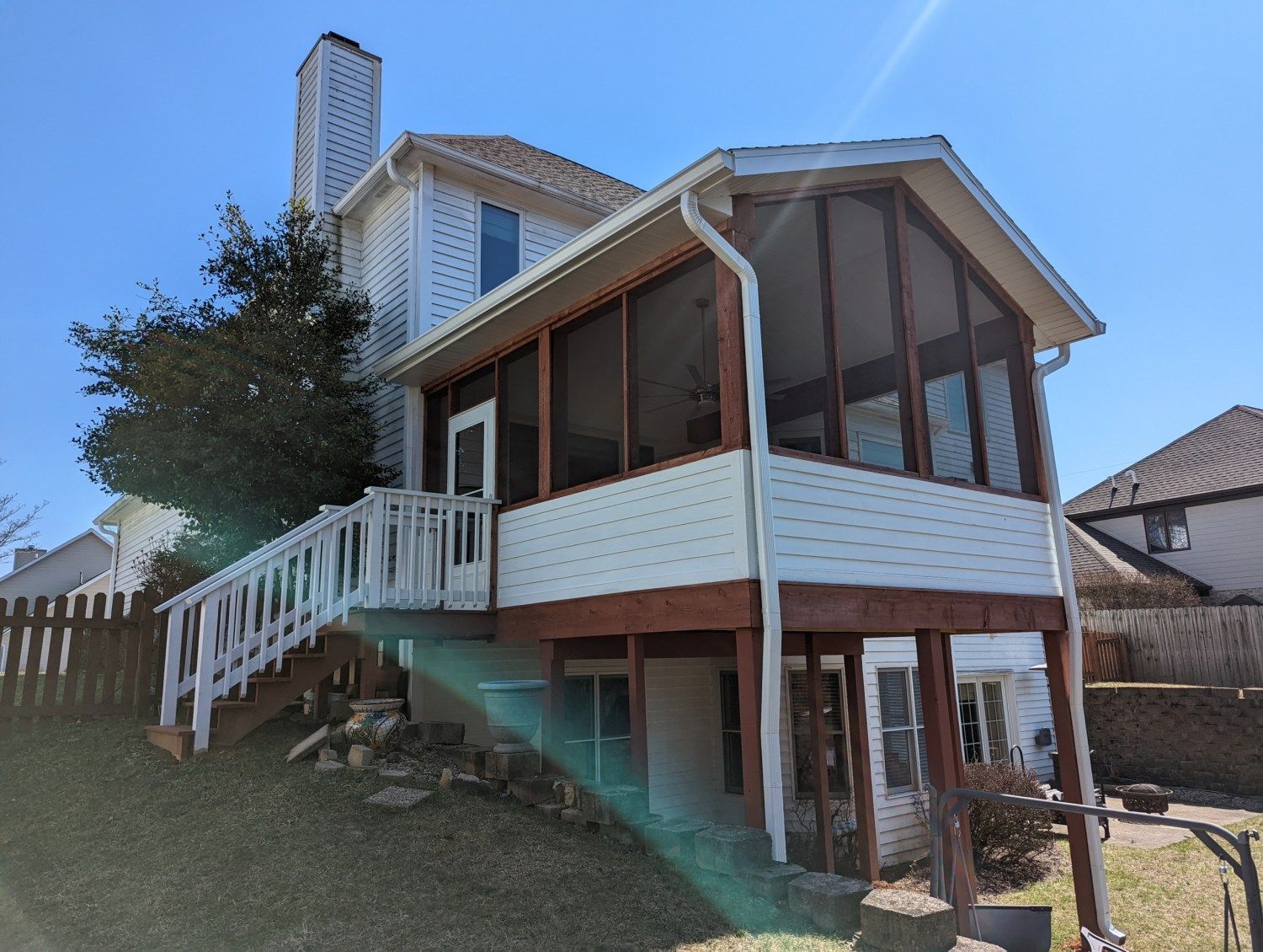 A house with a screened in porch and stairs