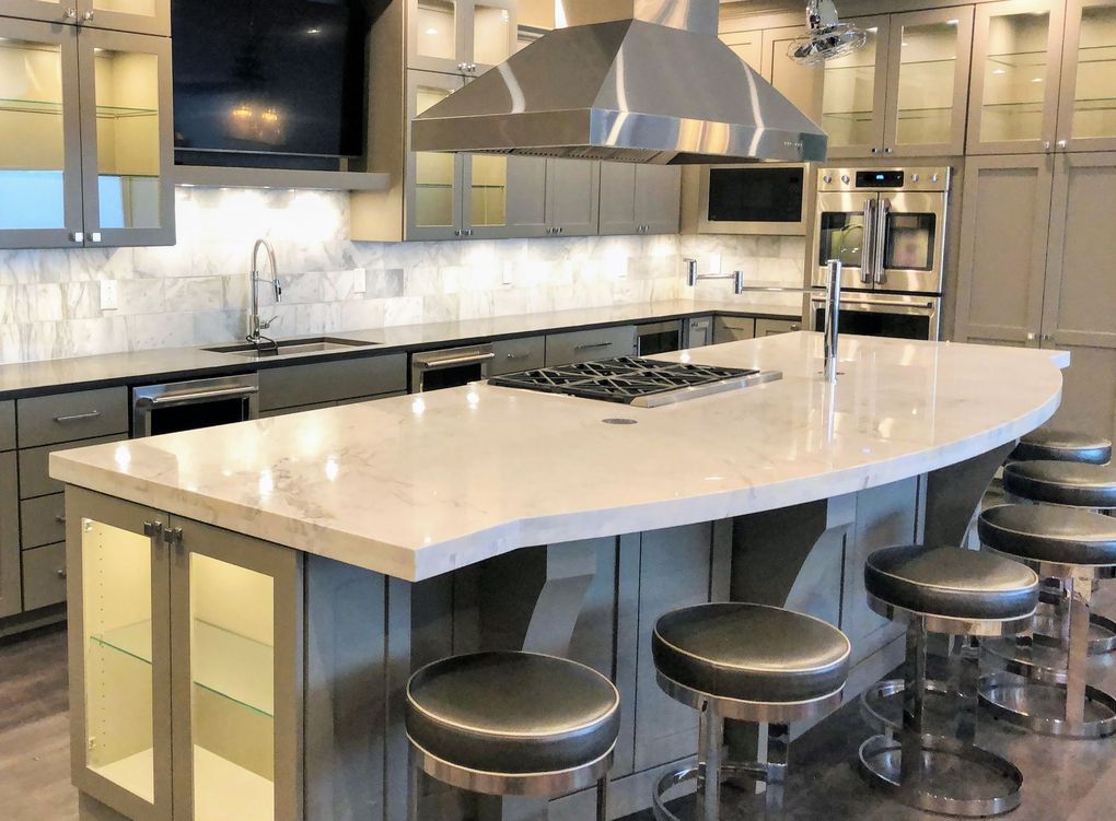 A kitchen with a large island and stools