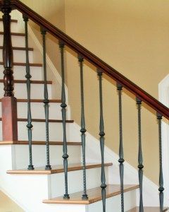 A staircase with a wooden railing and a metal railing