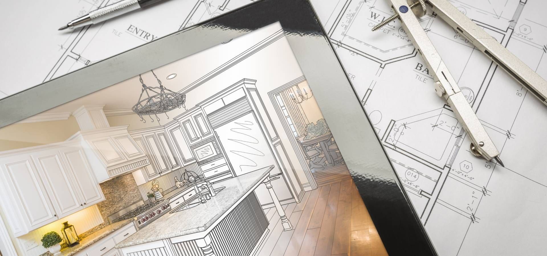 A drawing of a kitchen on a tablet next to a compass and pencil.