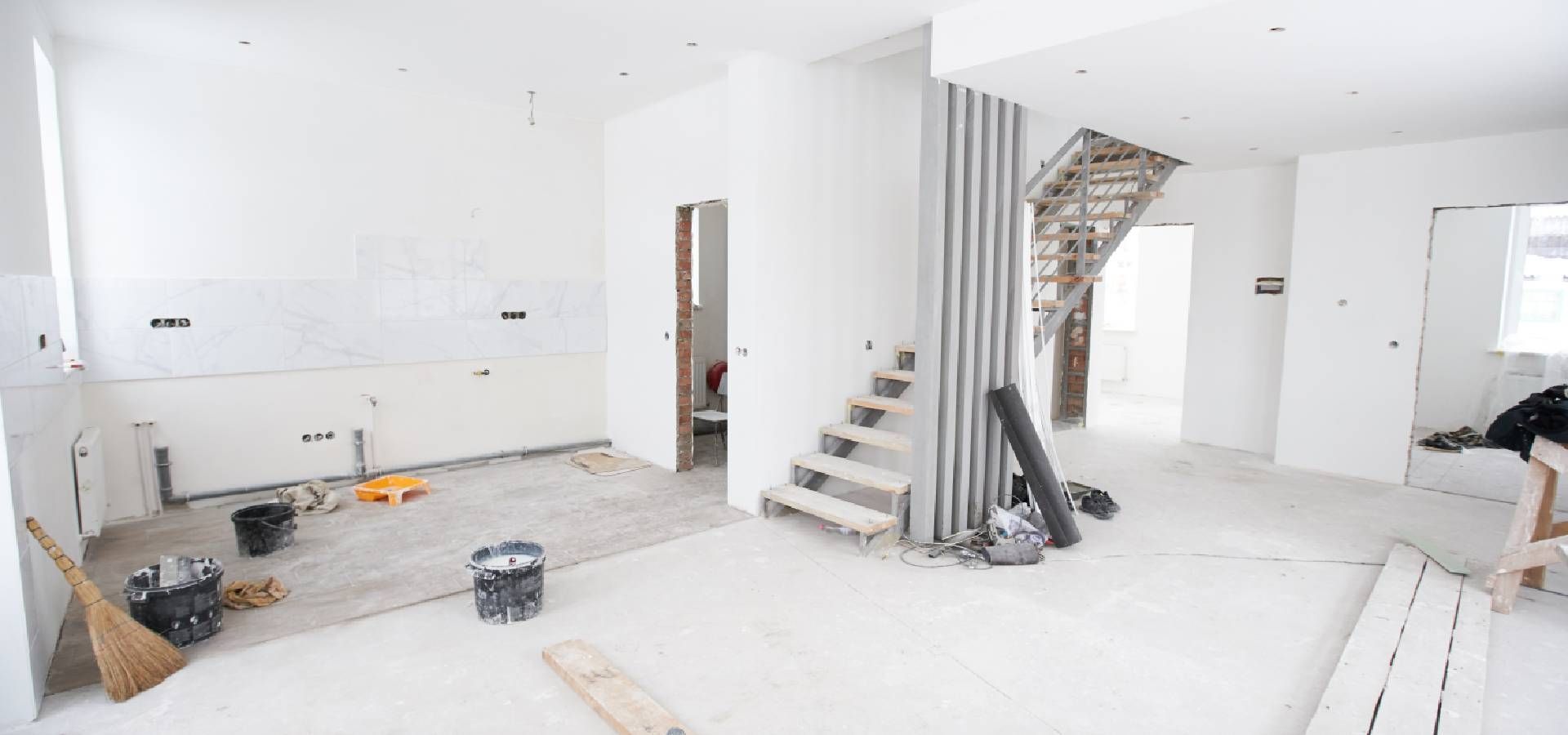 An empty room with a staircase in the middle of it.