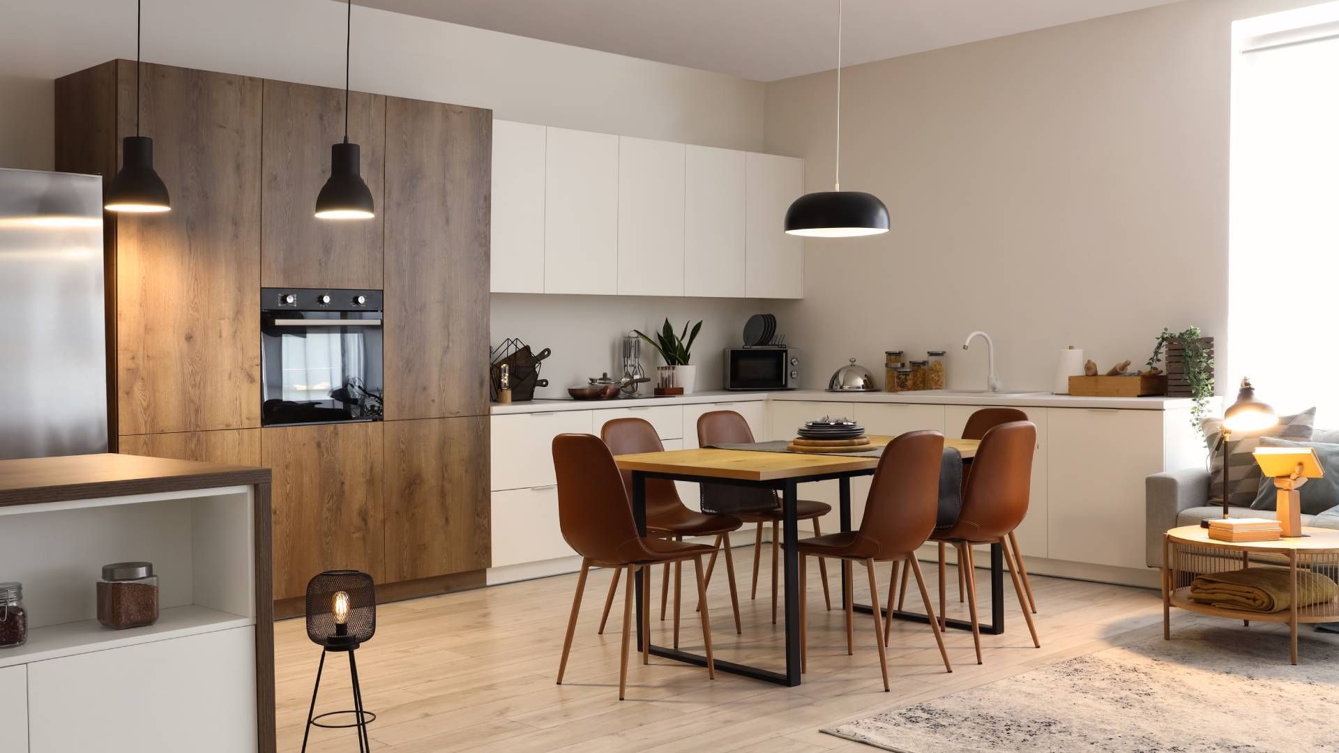 A kitchen with a dining table and chairs in it.