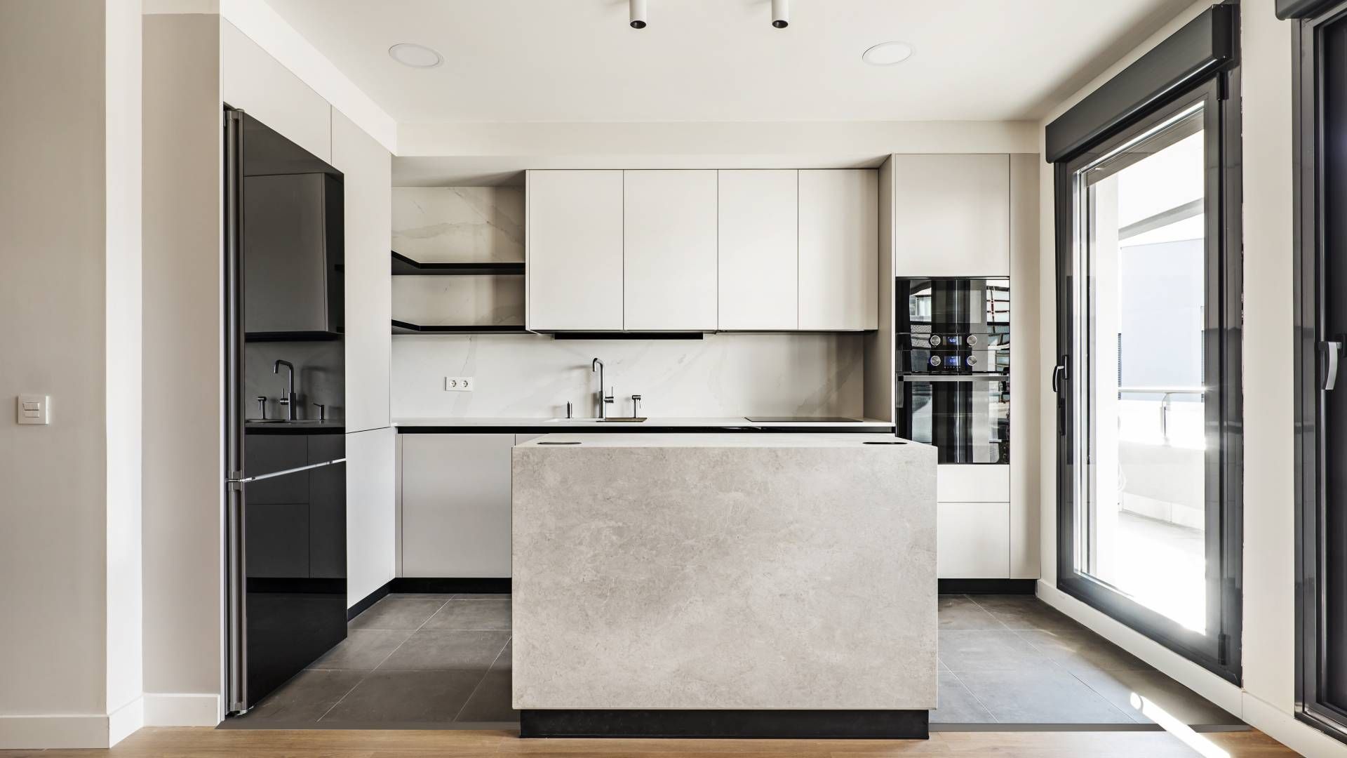 There is a large island in the middle of the kitchen.