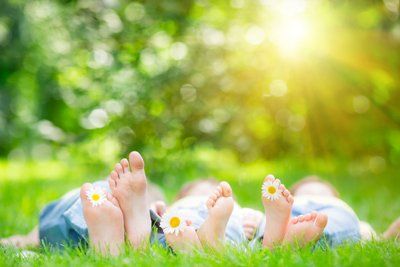 Family Lying On Grass — Newport, RI — Newport Family Foot Care