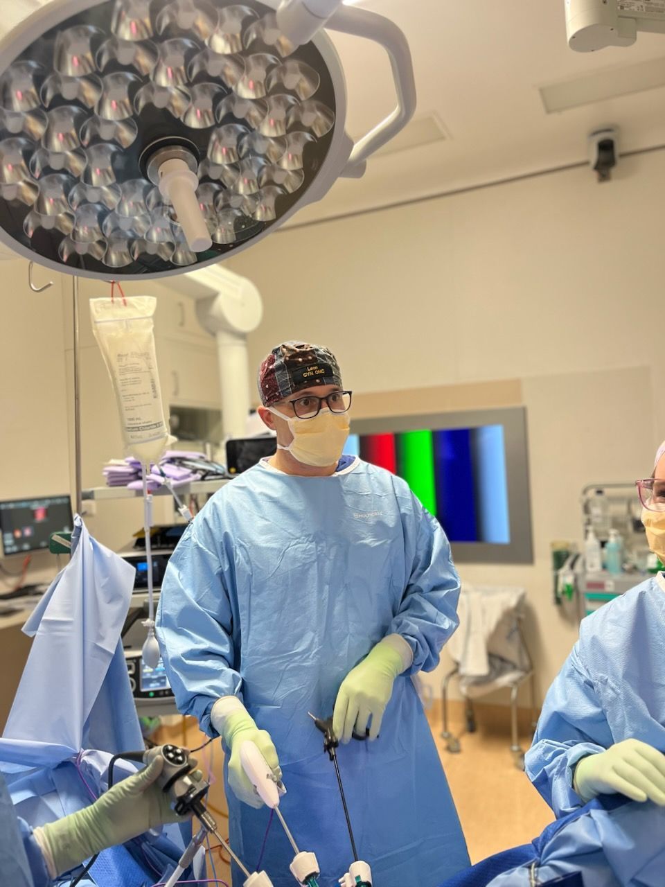 A group of surgeons are performing surgery in an operating room